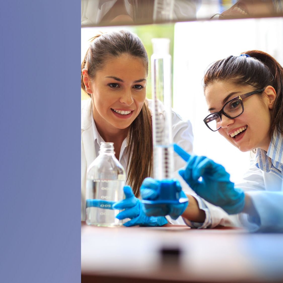 Two women and a boy in a laboratory setting with scientific equipment.