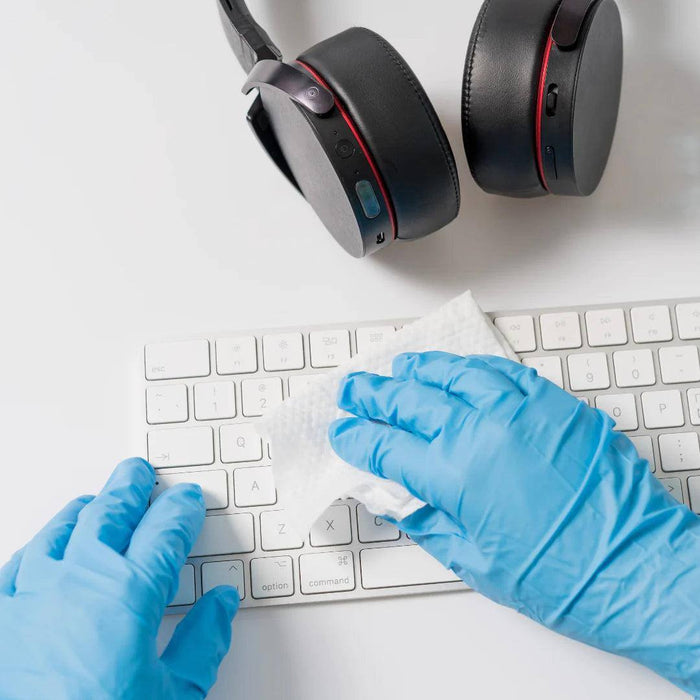 Cleaner Wearing GP Craft 4.4 MIL Blue Nitrile Exam Gloves While Disinfecting Keyboard