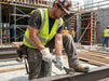 Construction worker using a hammer on a construction site wearing Tuff Gard Split Leather Reinforced Glove