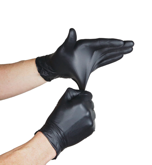Black gloves being worn on a white background