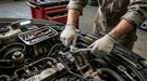 Mechanic working on a car engine with tools in a garage setting wearing Tuff Gard Cotton/Polyester Knit Glove