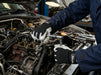 Mechanic working on a car engine in a garage wearing Tuff Gard Leather Palm Mechanic Glove – Grey & Black | Vizocare