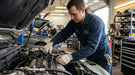 Mechanic working on a car engine in a garage while wearing Tuff Gard Cotton/Polyester Knit Glove