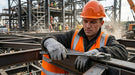 Worker in high-visibility safety gear at a construction site